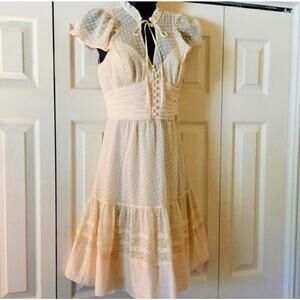 BCBGMAXAZRIA cream tie neck Swiss dot dress with ruffle neck and sleeves Size 2